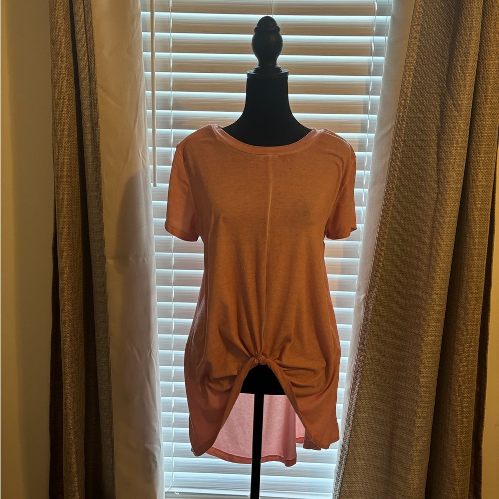 Short-sleeved shirt in front long in back shirt. Peach color.  Size Medium.
